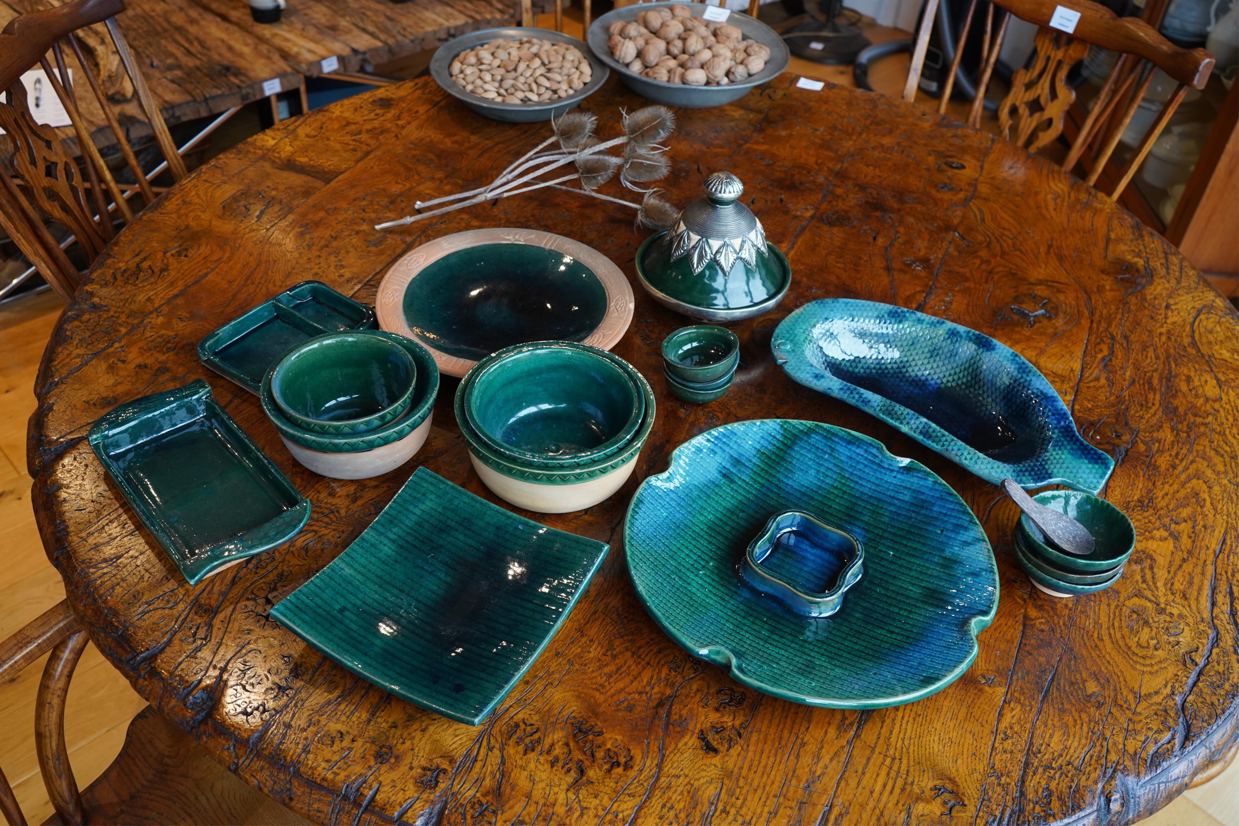 A collection of Rajasthan green glazed ceramics to include large dishes, bowls and square dishes, together with other mixed pottery, largest 40cm in diameter. Condition - mostly good